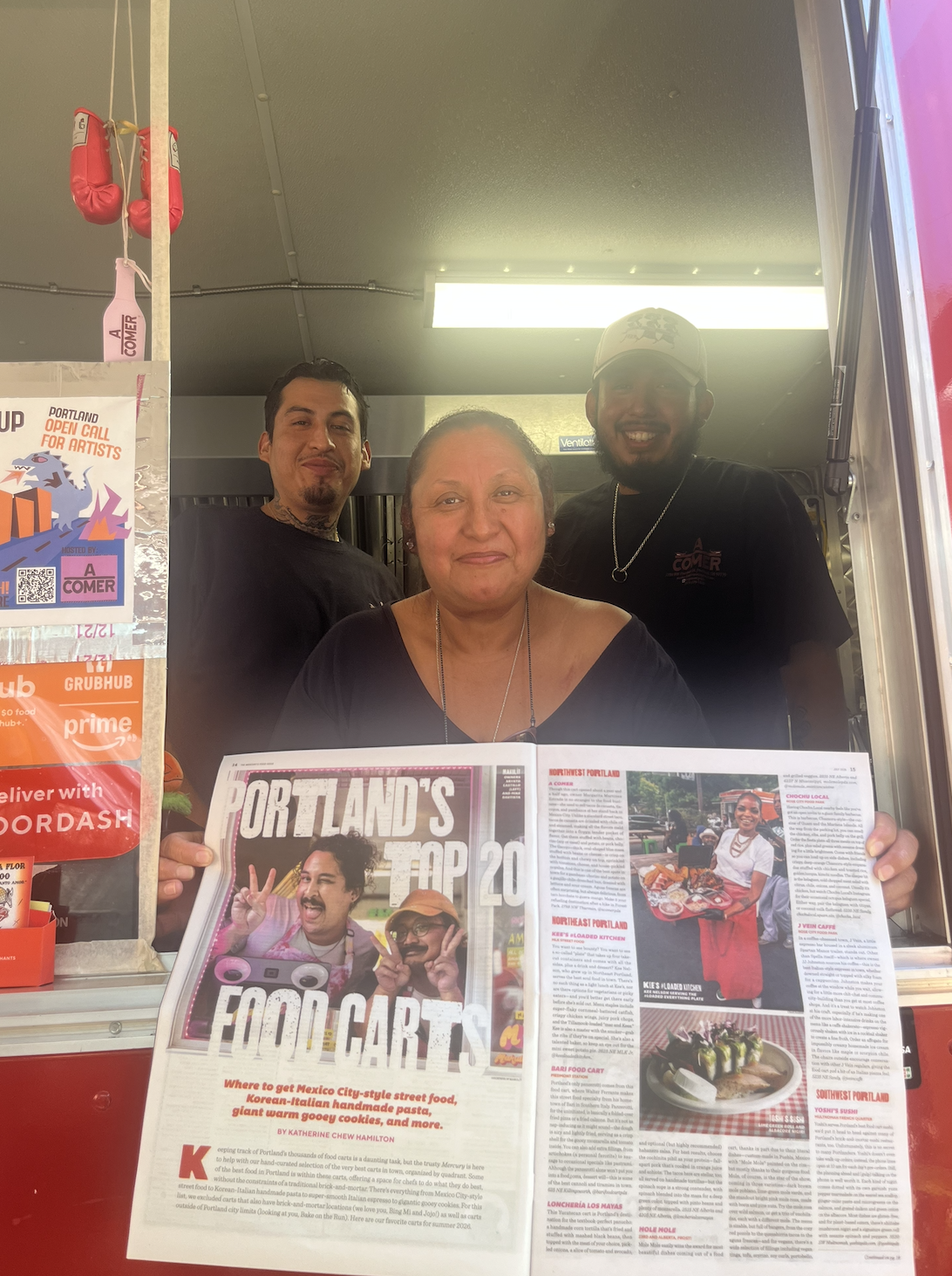 The A Comer team together at the food cart, holding a Portland food cart feature